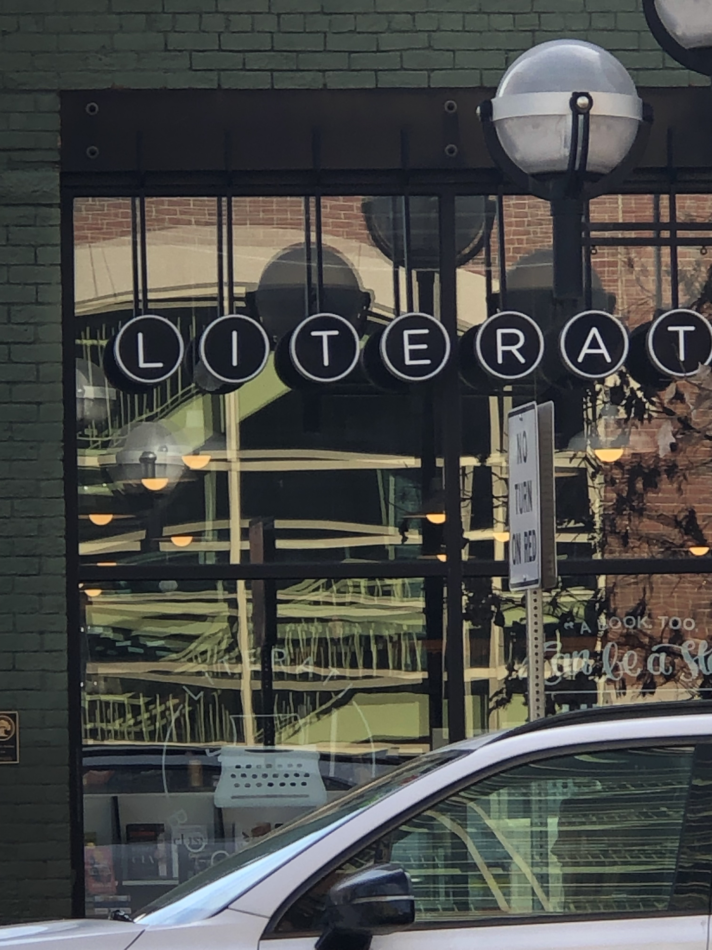 A store window with letters spelling out most of the name Literati.