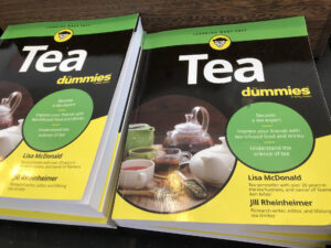 Green, yellow and black books with "Tea" in large letters, and "dummies" in smaller letters sit on a counter.