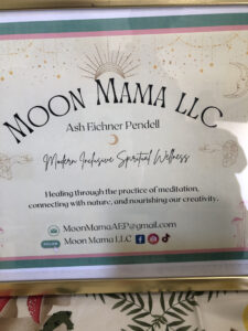 Close up of sign showing Moon Mama LLC and Ash's full name and credentials for the LLC.