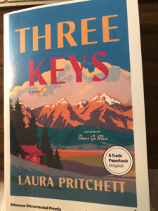 The cover of the book Three Keys by Laura Pritchett. A mountain scape with a colorful array. 