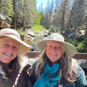 The same two women stand on the same bridge three years earlier.